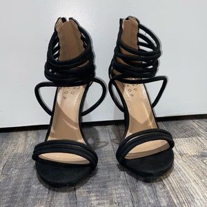 Black strappy heels from a boutique.